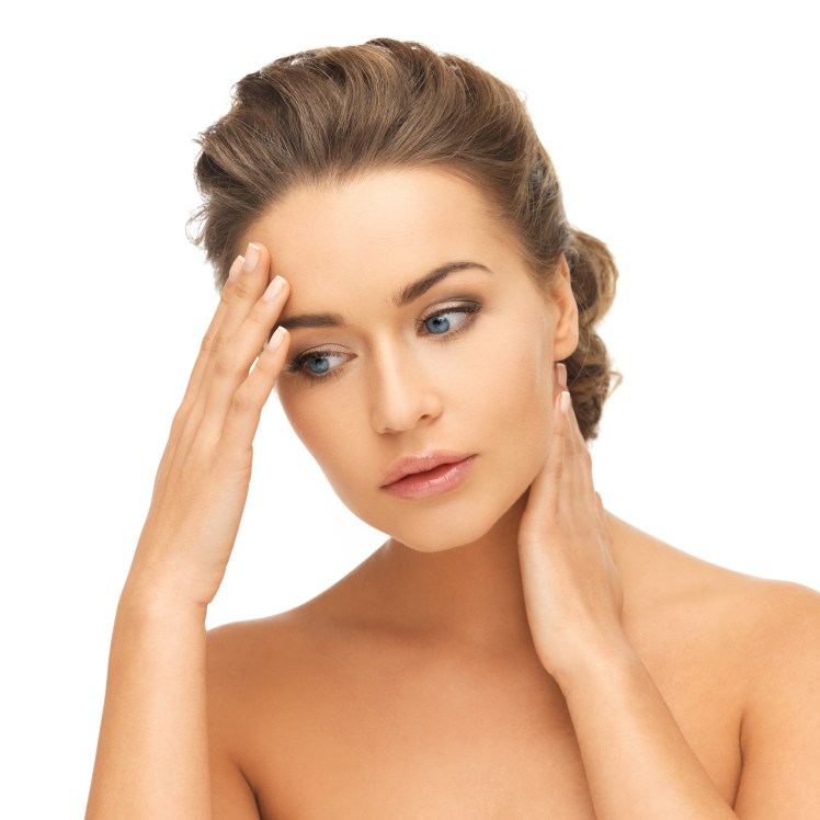 woman holding hands on her neck and forehead